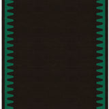 Waver Rug in Modernist Green, a solid black field with a green flame stitch border. 