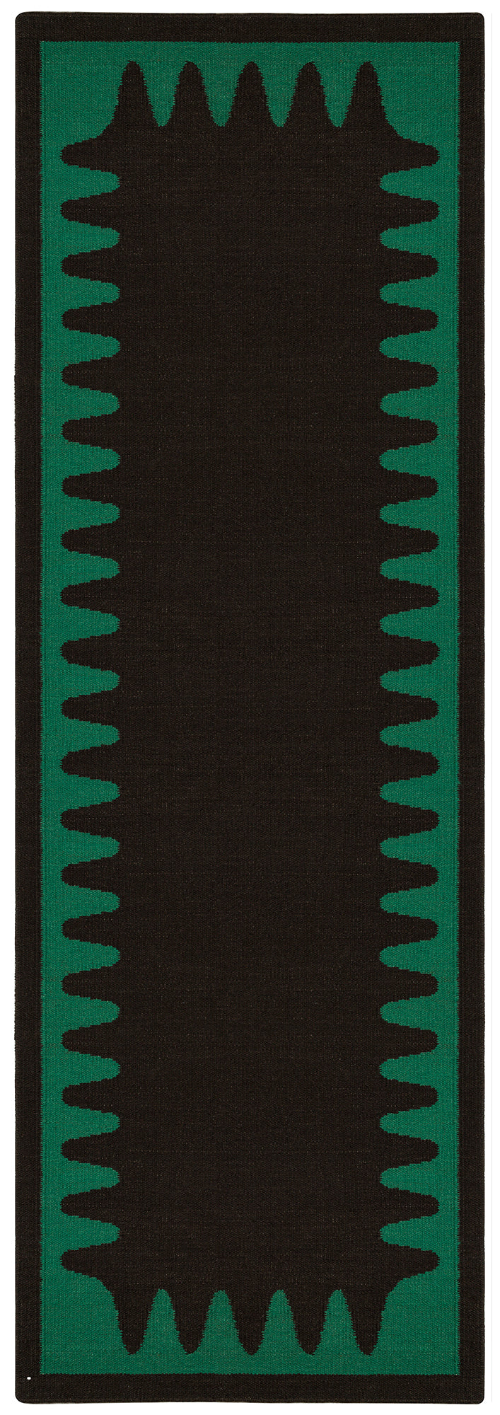 Detail of the Waver Rug in Modernist Green, a solid black field with a green flame stitch border. 