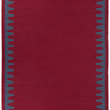 Waver Rug in Queensdown Red, a solid red field with a blue flame stitch border. 