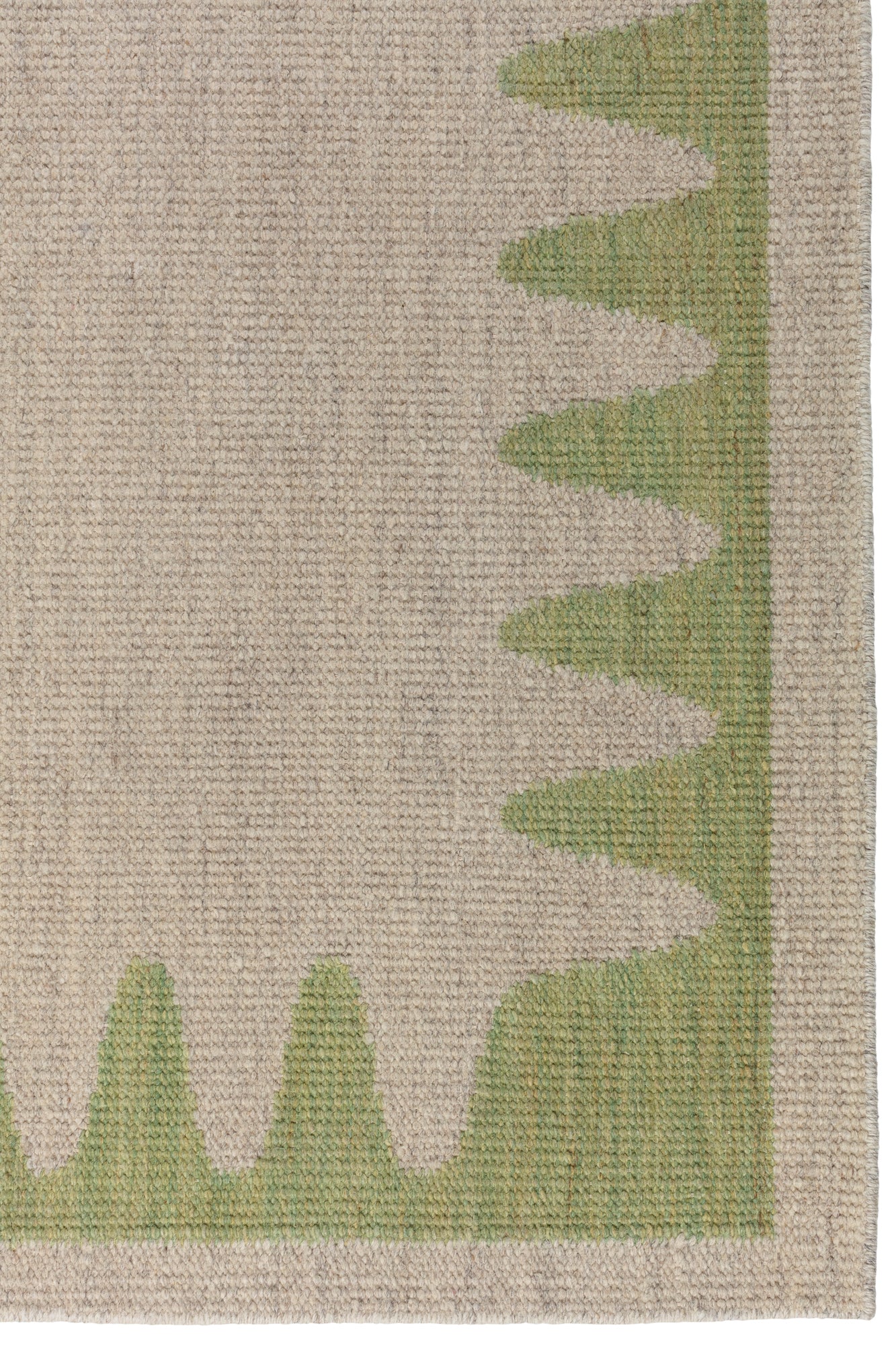 Detail of the Waver Rug in Sage, a strated taupe field with a sage green flame stitch border. 