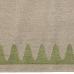 Detail of the Waver Rug in Sage, a strated taupe field with a sage green flame stitch border. 
