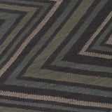 Detail of To The Point Rug in Pyrite-Metallic, a zig zag pattern in dark greens, metallic ecru and black.
