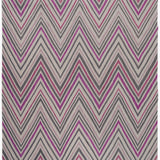 Zig Zag Rug in Ruby-Rose, a mutli color zig zag pattern in fucshia, magenta, link and charcoal on a white field with a tassled edge. 