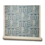 Abbot Kinney grasscloth roll: the design is geometric with triangles and squares in a teal color printed on textured grasscloth