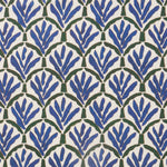 Woven fabric swatch with a repeating Moroccan-inspired scallop pattern in blue and green on a white background.
