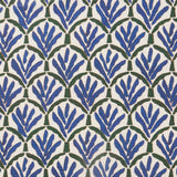 Woven fabric swatch with a repeating Moroccan-inspired scallop pattern in blue and green on a white background.